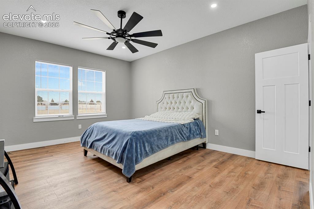 Image 29 of 49: Recessed ceiling lighting, wood-finish flooring, and a modern ceiling fan w