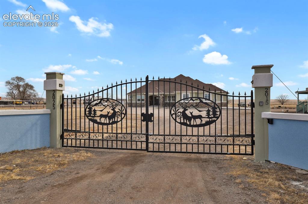 Image 6 of 49: Decorative wrought iron gate with custom deer and mountain motif
