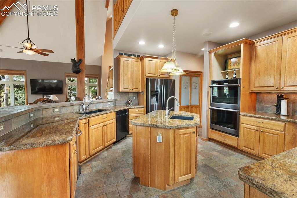 Image 10 of 36: All that cabinet space plus gorgeous live edge granite countertops!
