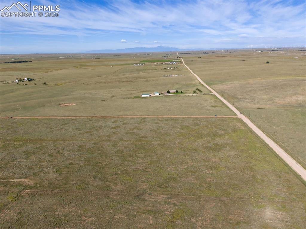 Image 11 of 12: Aerial view of sparsely populated area featuring a mountain backdrop