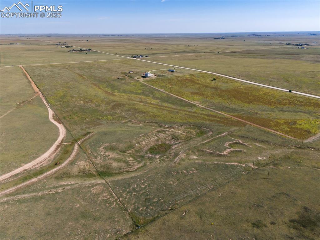 Image 7 of 12: Aerial view of property and surrounding area featuring rural landscape