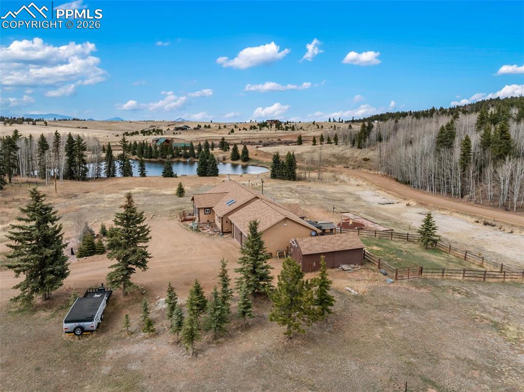 Image 3 of 50: Ariel view of property and community pond