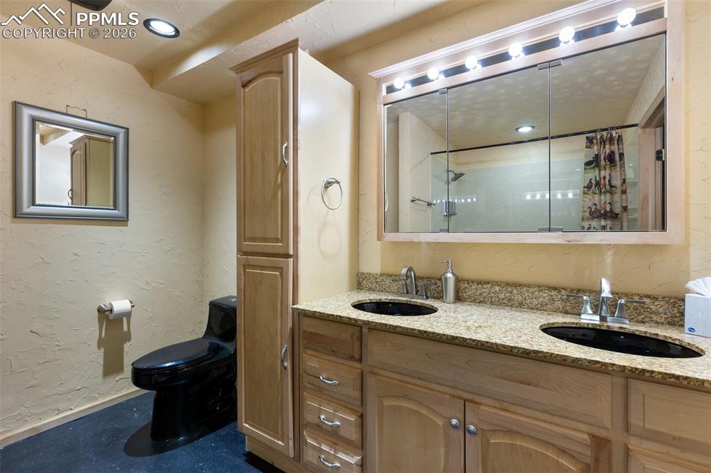 Image 42 of 50: Family room in basement with wood burning stove