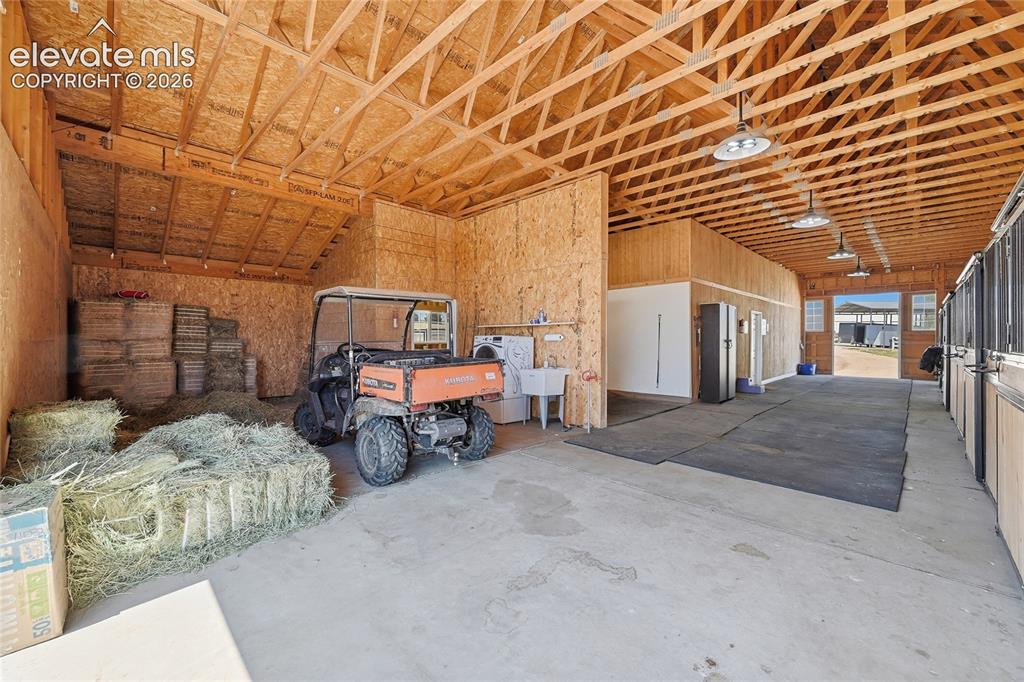 Image 4 of 43: Spacious barn interior featuring hay and equipment storage