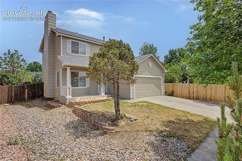 Image 15 of 18: Two-story residence featuring light-toned siding, white window trim with sh