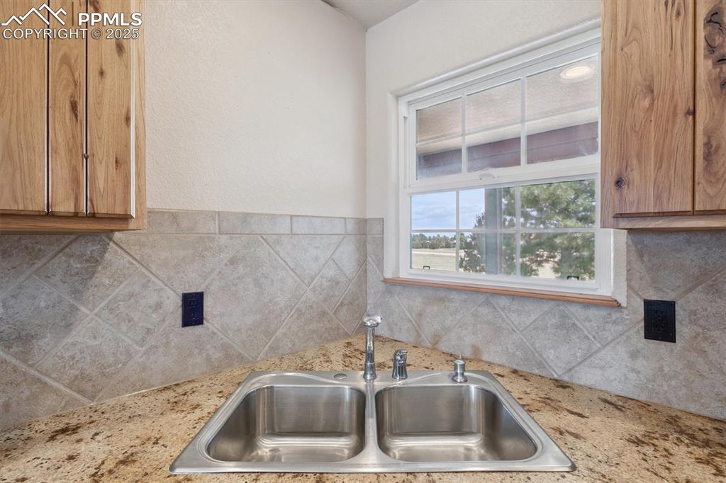 Image 15 of 42: Sink looking out front window