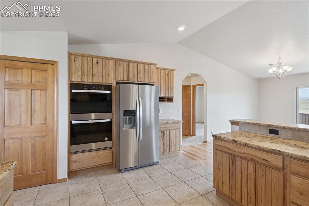 Image 16 of 42: Kitchen pantry, refrigerator and double oven