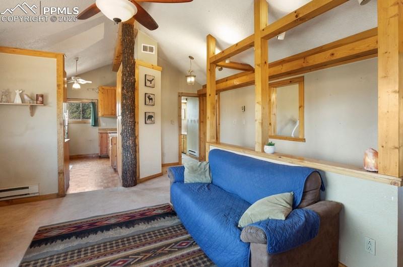 Image 11 of 32: Carpeted living room with a ceiling fan, lofted ceiling, a baseboard radiat