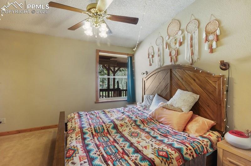 Image 15 of 32: Carpeted bedroom featuring a textured ceiling and ceiling fan