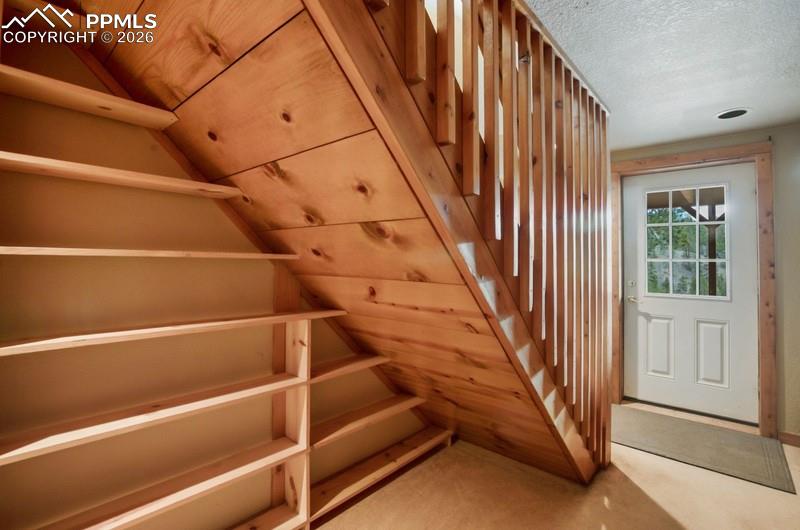 Image 22 of 32: Stairs with a textured ceiling