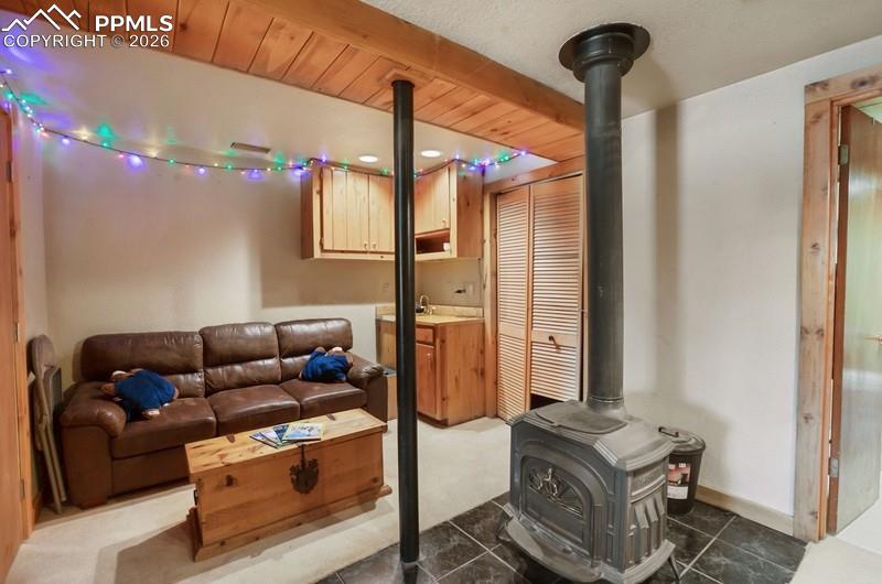 Image 23 of 32: Living area with a wood stove