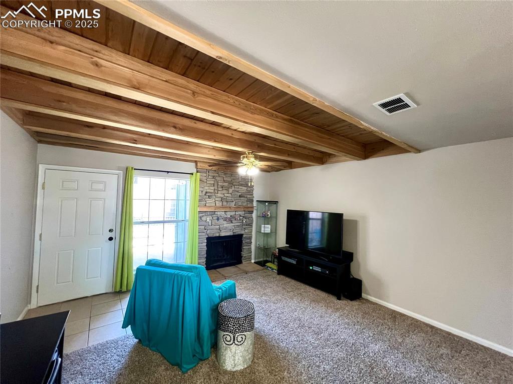 Image 3 of 24: Living room with wood beamed ceiling