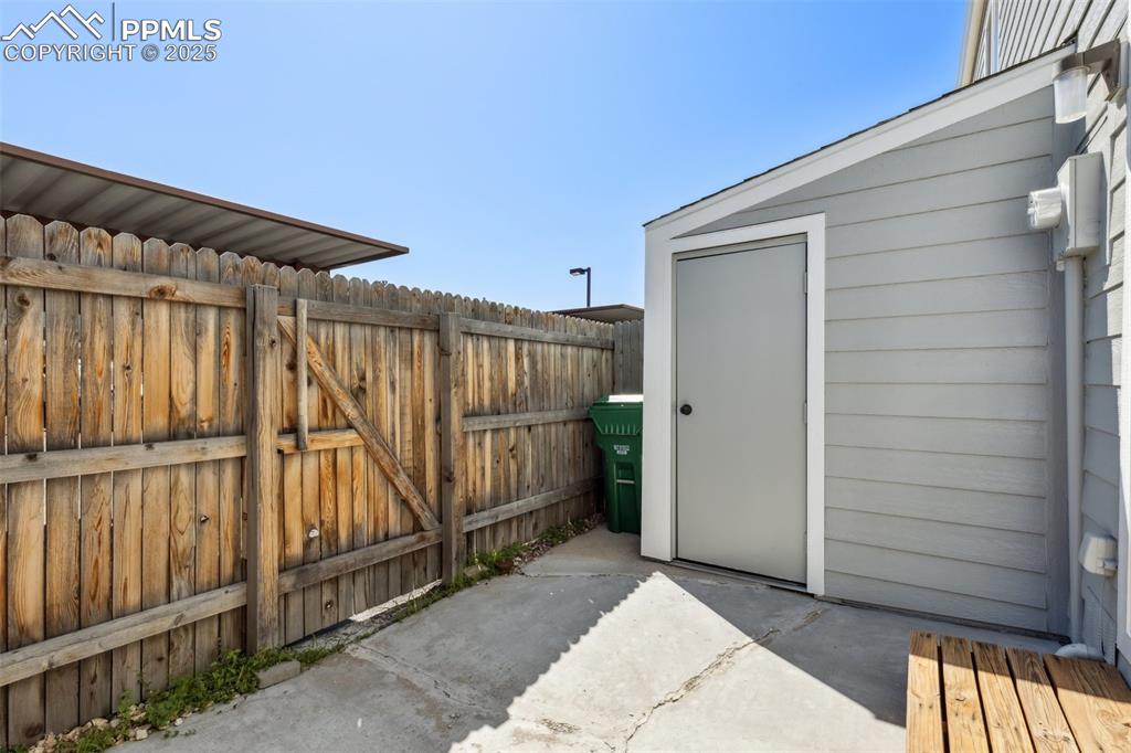 Image 13 of 24: Enclosed patio, storage closet and access to the crawl space