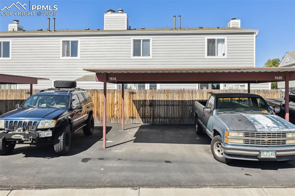 Image 22 of 24: Dedicated carport for each unit. Gate access into enclosed patio area.
