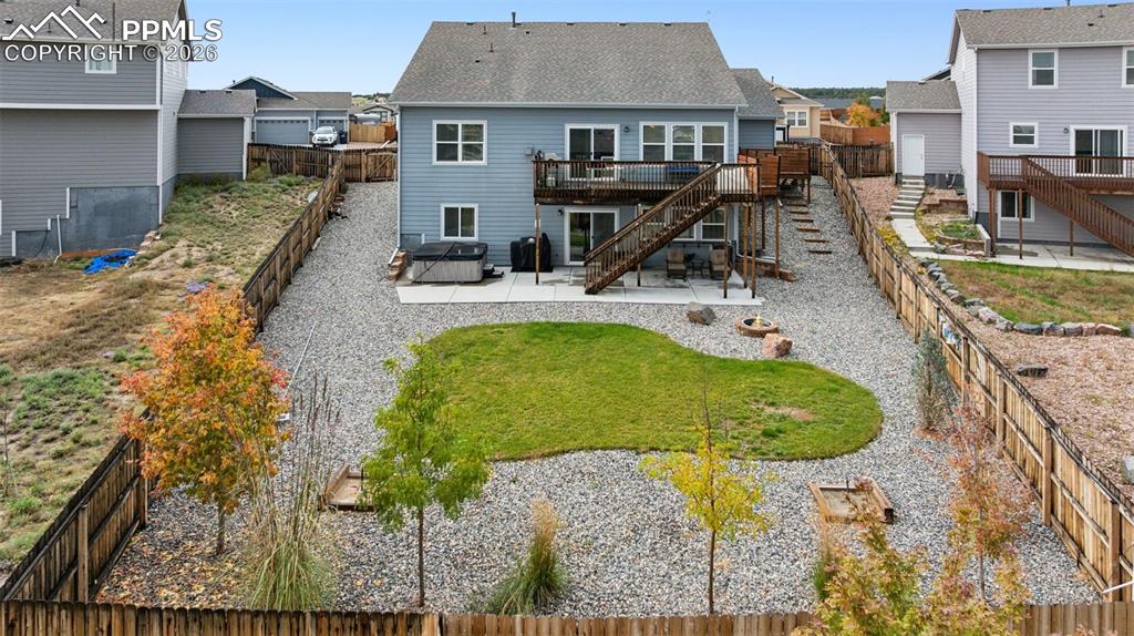 Image 4 of 40: Back of home featuring large, privacy fenced back yard that is well maintai