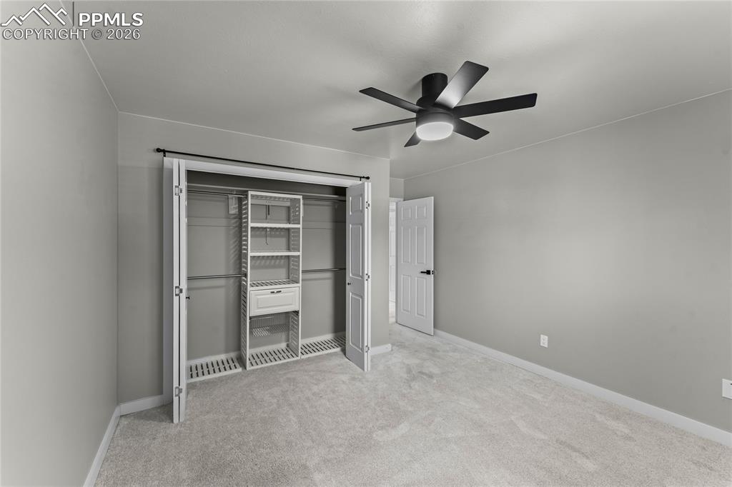 Image 23 of 50: Sophisticated third bedroom highlighted by a professional custom closet ins