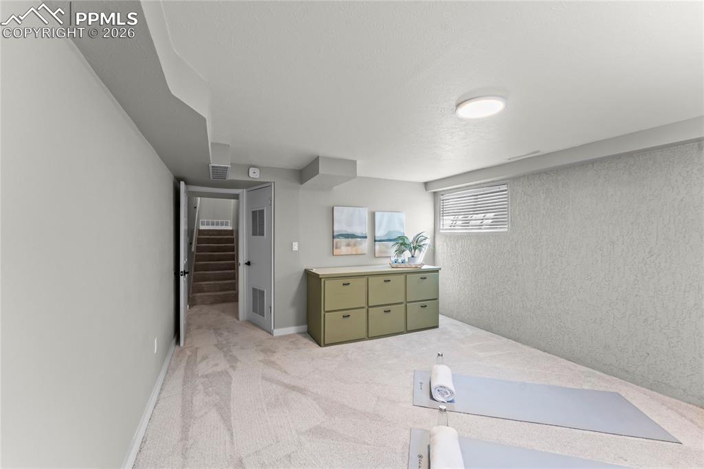 Image 35 of 50: Expansive lower-level bonus room, perfect for an exercise suite or hobby ro