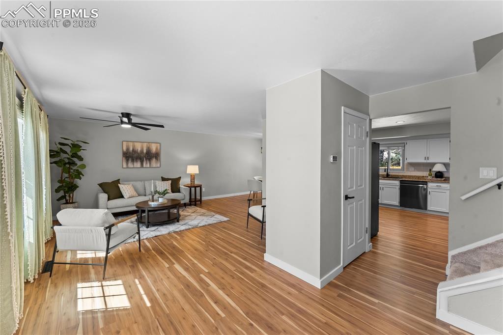 Image 7 of 50: Expansive open-concept living area bathed in natural light, featuring conte