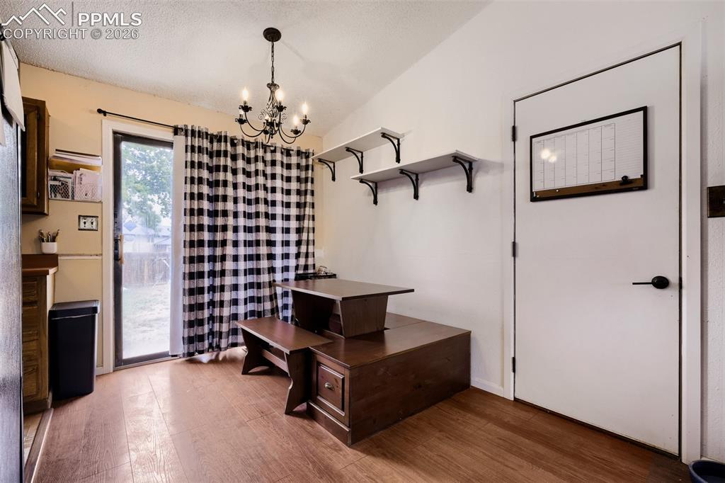 Image 13 of 28: Kitchen with wood-finish flooring, wood cabinetry, and a double basin stain