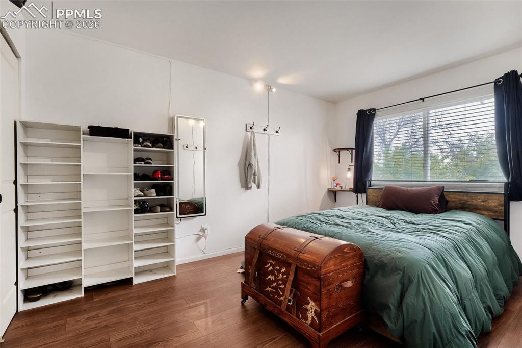 Image 16 of 28: Kitchen area featuring wood-finish flooring, oak-tone cabinetry, and a blac