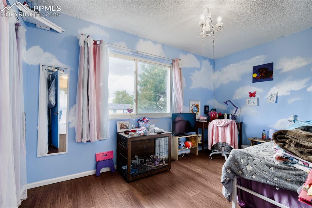 Image 19 of 28: Interior space featuring wood-finish flooring and a white ceiling with a te