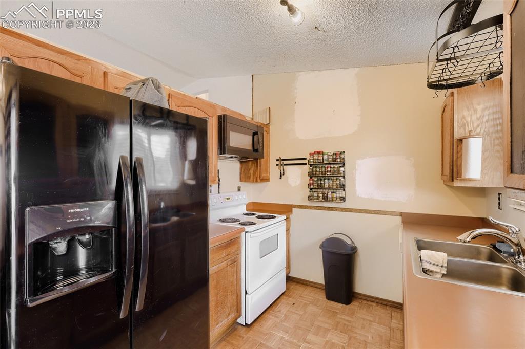 Image 9 of 28: Living area with wood-finish flooring and a single window featuring horizon