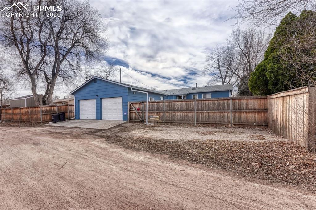Image 31 of 33: Additional parking off the alley has enough space to add a carport