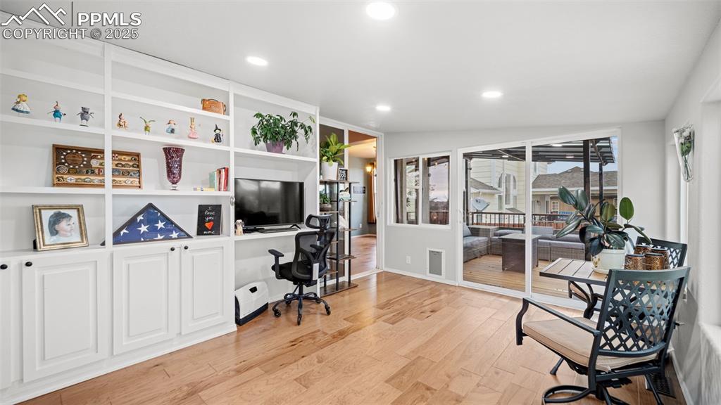 Image 15 of 42: Home office featuring light wood finished floors and recessed lighting