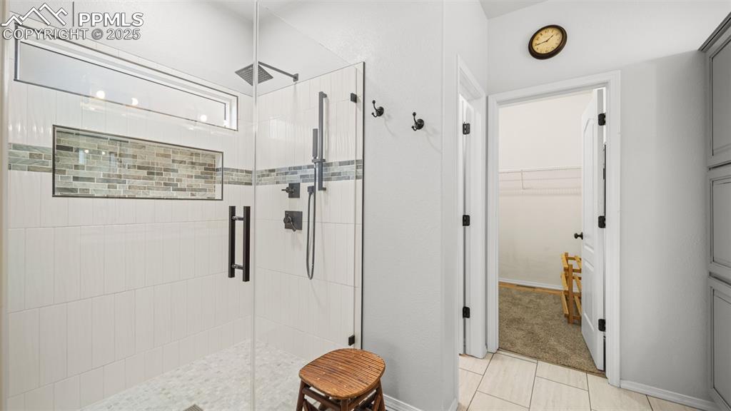 Image 22 of 42: Bathroom featuring a shower stall and a spacious closet
