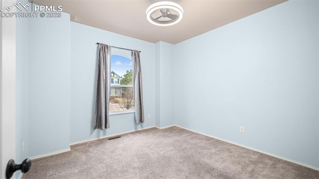 Image 24 of 42: Spare room with carpet flooring and baseboards