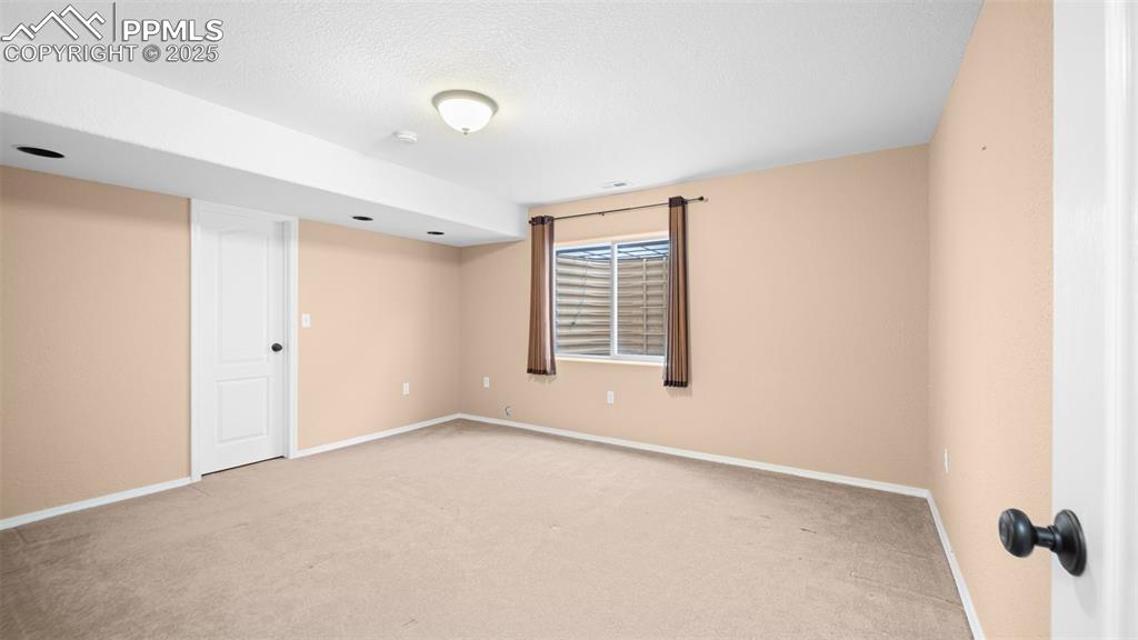 Image 28 of 42: Bedroom with light carpet and a textured ceiling