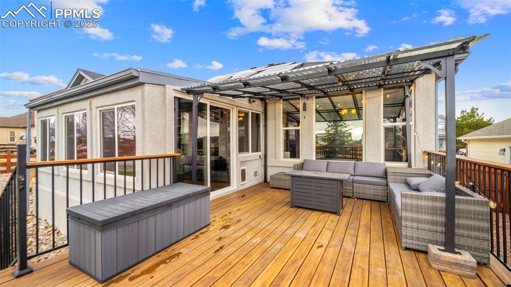 Image 32 of 42: Wooden terrace featuring an outdoor hangout area