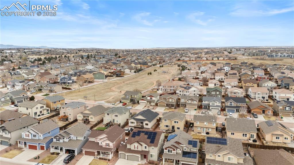 Image 37 of 41: Backyard with hot tub, grill and cement patio.