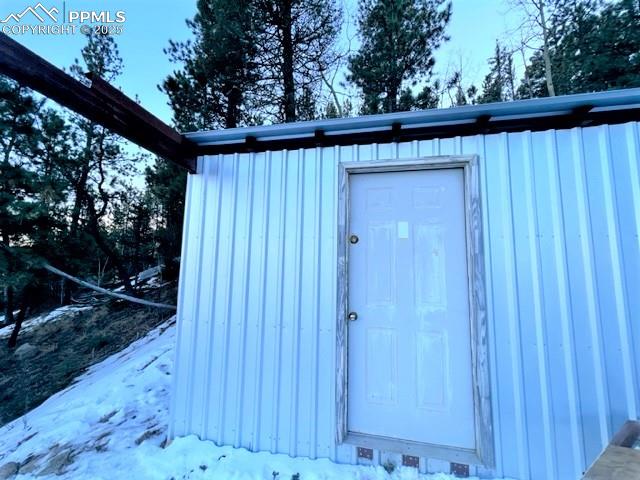 Image 9 of 21: Snow covered structure featuring a storage shed