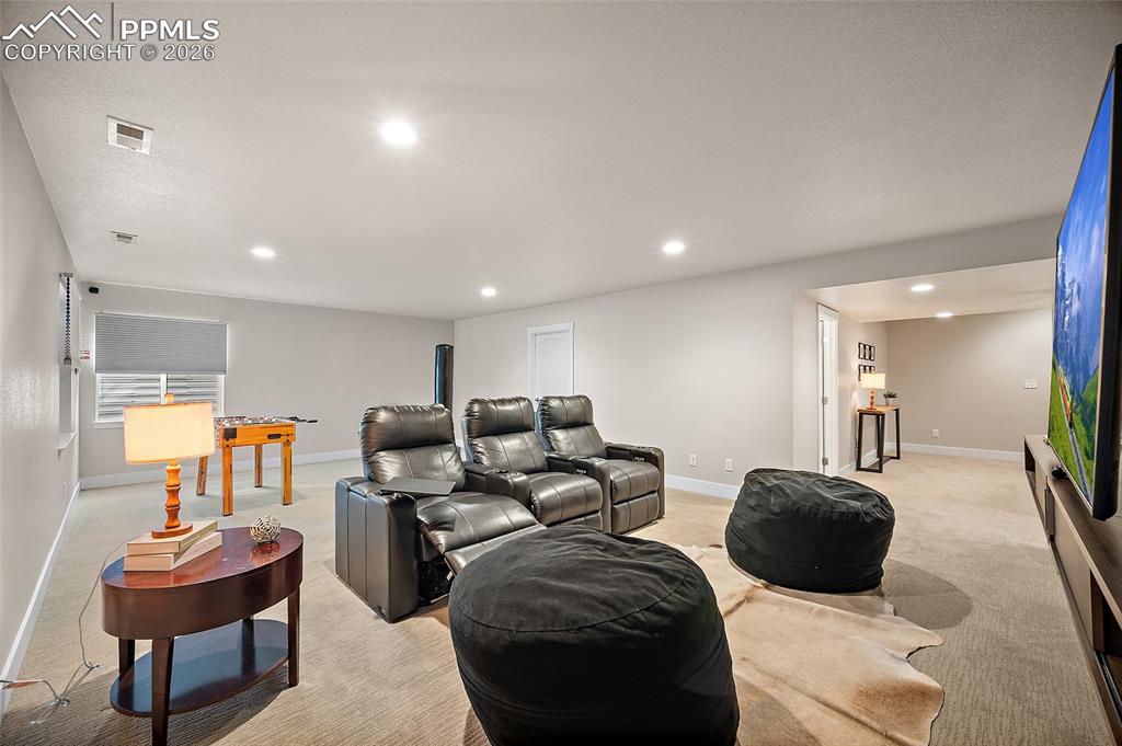 Image 20 of 45: Cinema featuring light carpet and recessed lighting