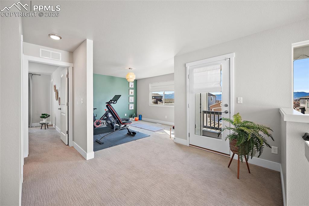 Image 26 of 45: Work out room with Pikes Peak views - Potential 4th bedroom upstairs.