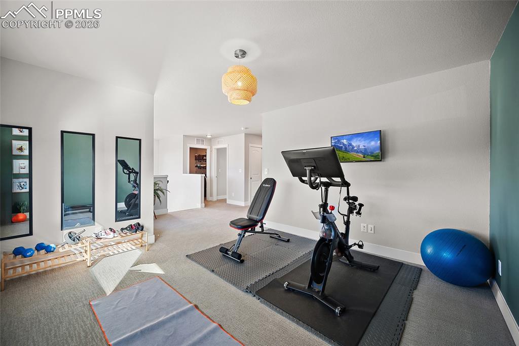 Image 28 of 45: Workout room with carpet floors and baseboards