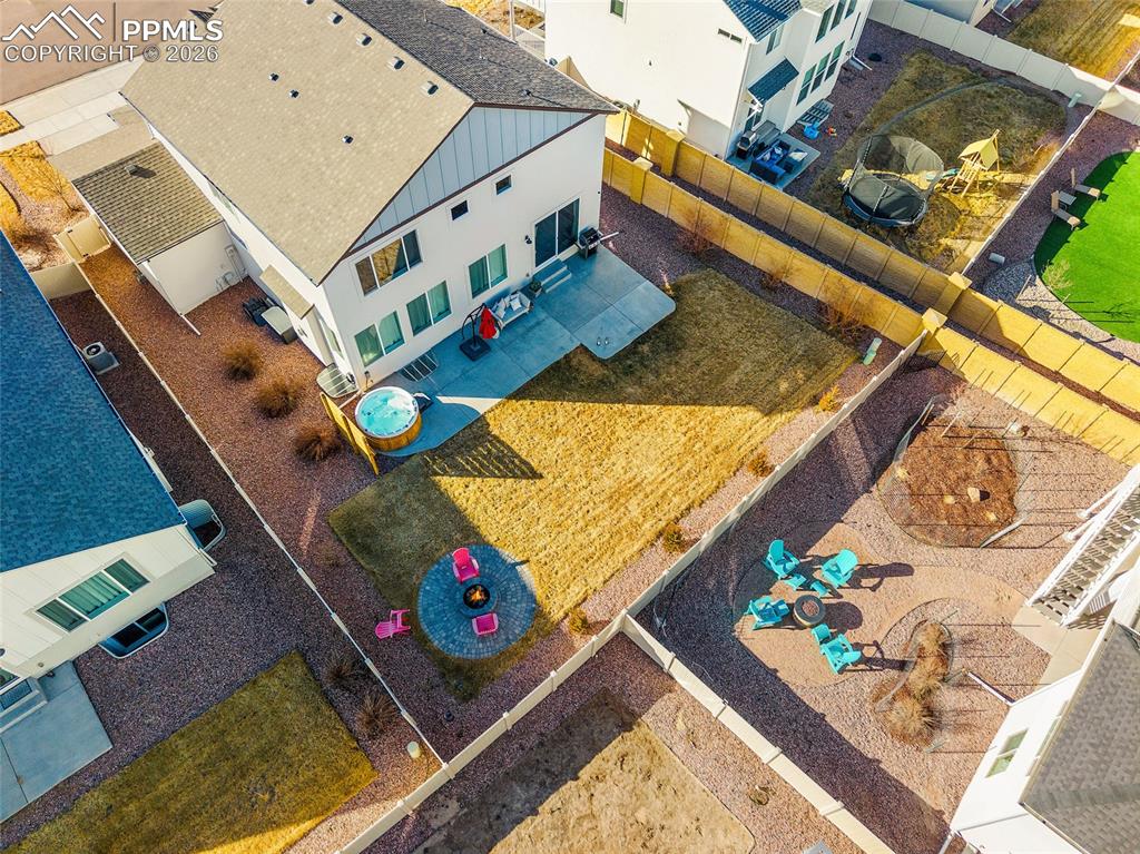 Image 39 of 45: Backyard with fireplace, big open area and round cedar jacuzzi