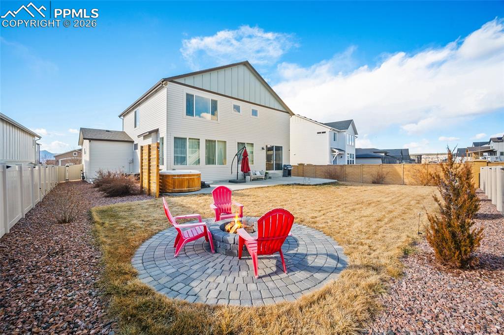Image 40 of 45: Rear view of property featuring a patio area, a fenced backyard, board and 