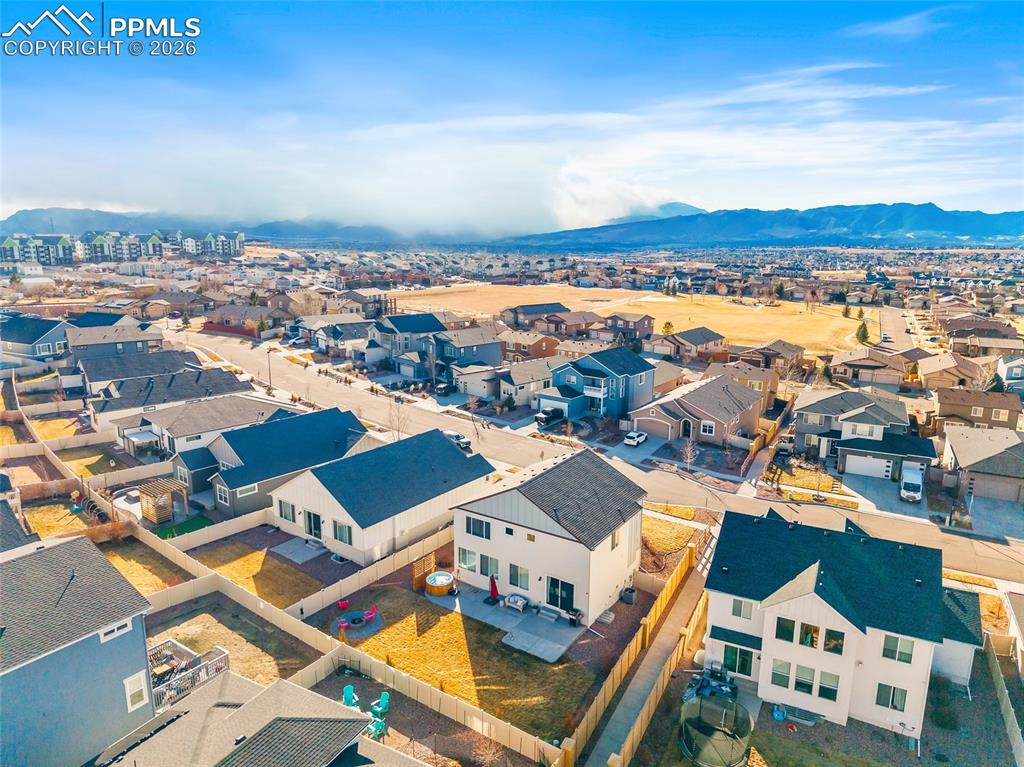 Image 44 of 45: Aerial view of residential area featuring mountains