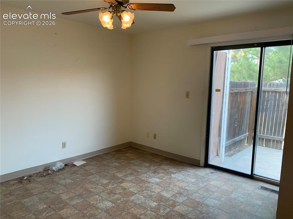 Image 11 of 27: Interior space with patterned tile-style flooring, a ceiling fan with integ