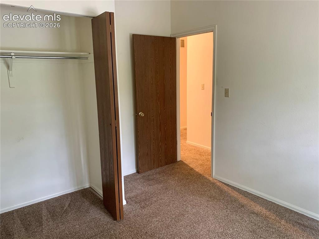 Image 12 of 18: Wall-to-wall carpeting with light-colored walls and white trim