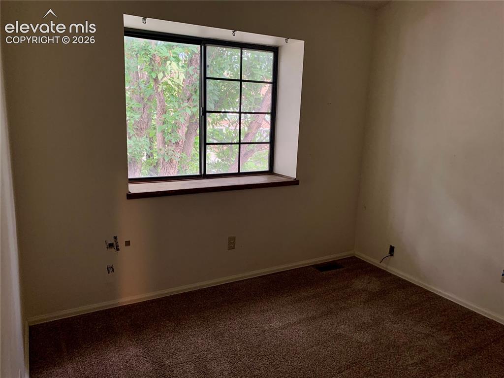 Image 14 of 18: Window with dark framing and a wide sill