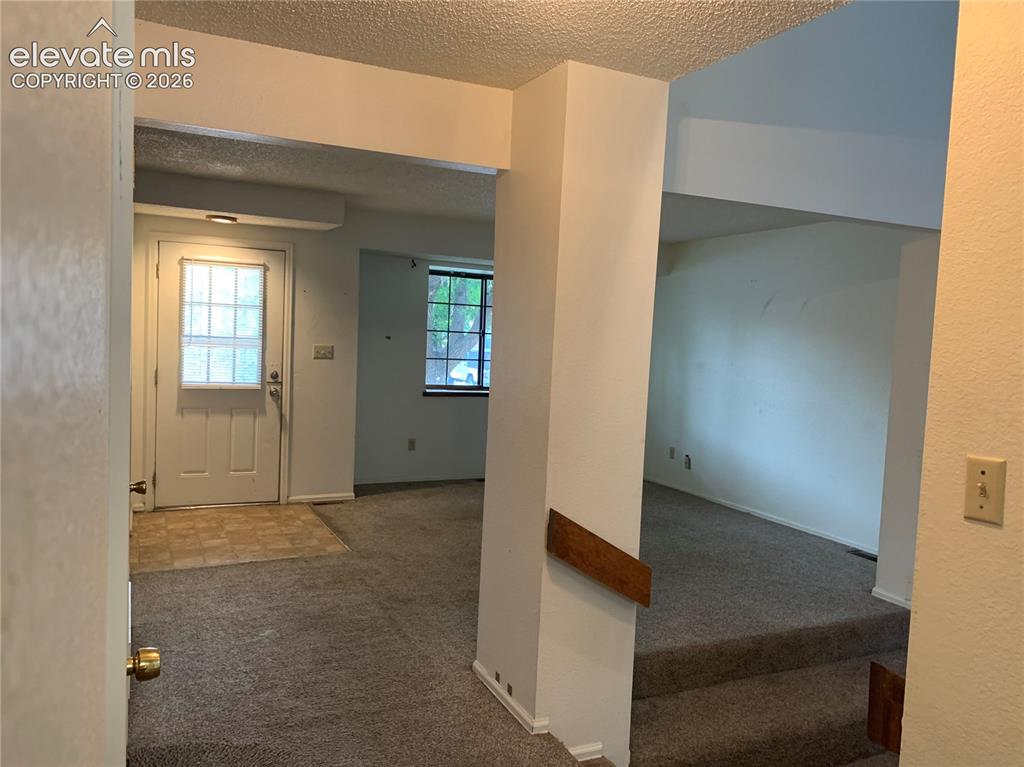 Image 18 of 27: Entry area with a paneled door featuring multiple glass inserts, complement