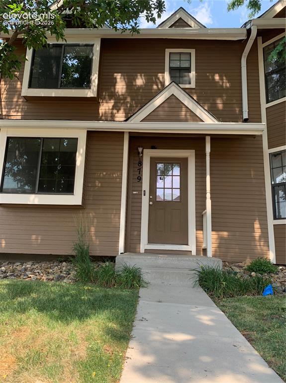 Image 2 of 27: Townhome exterior featuring brown siding and white trim
