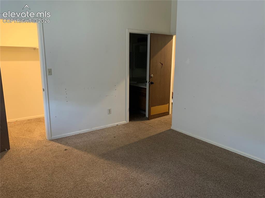 Image 24 of 27: Primary Bedroom shown walk-in closet and full primary bathroom.
