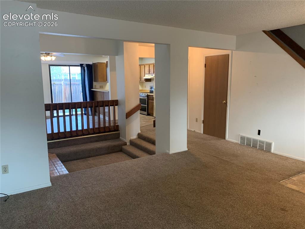 Image 4 of 27: Open living space on main floor.