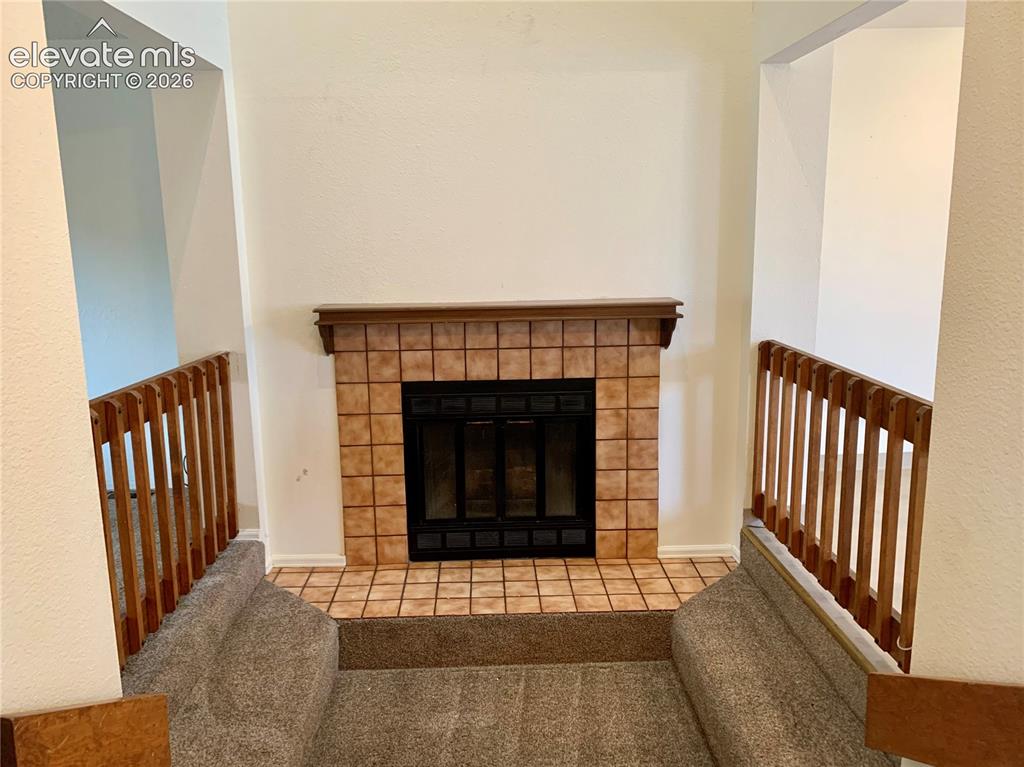Image 5 of 18: Living area fireplace.