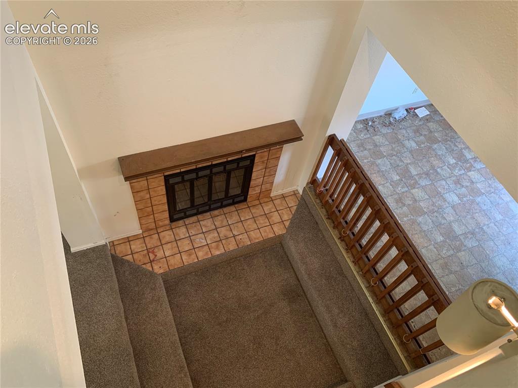 Image 6 of 27: Fireplace from upper floor from lofted ceiling.