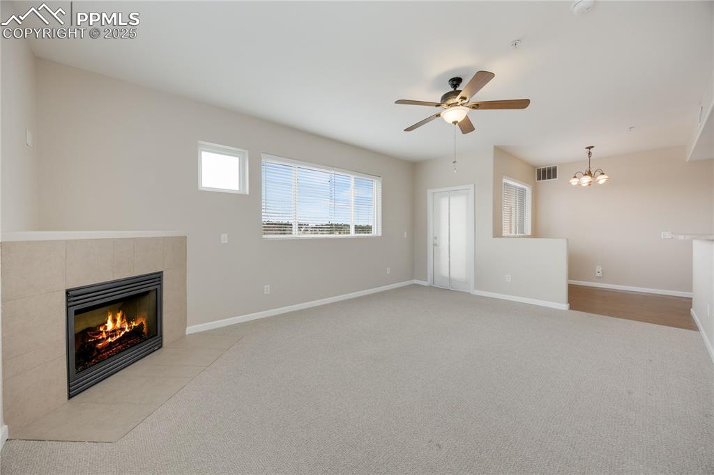 Image 12 of 42: Large family room has built-in natural gas fireplace